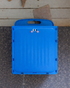 Blue folding stool with cartoon face on a concrete surface